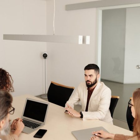 Man in White Suit Jacket Sitting Having an Interview